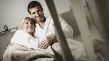Couples can relax together on the plush bed, surrounded by a serene atmosphere.