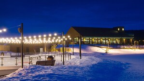 A snow-covered outdoor area with a building, benches, and a fence. - Suncadia Resort, a Destination by Hyatt Residence (Cle Elum)