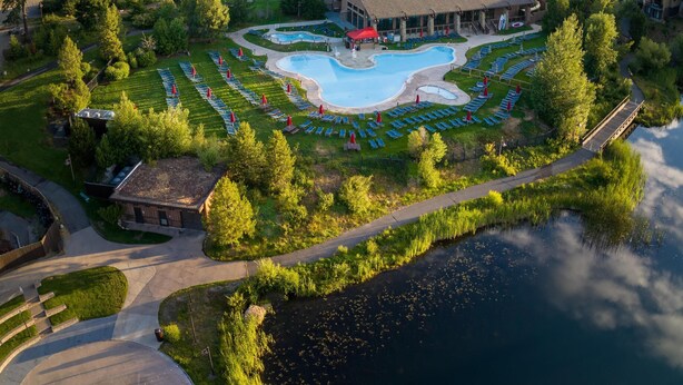 A resort with a swimming pool, a large building, and a forested area. - Suncadia Resort, a Destination by Hyatt Residence (Cle Elum)
