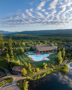 A resort with a swimming pool, a large building, and a forested area. - Suncadia Resort, a Destination by Hyatt Residence (Cle Elum)