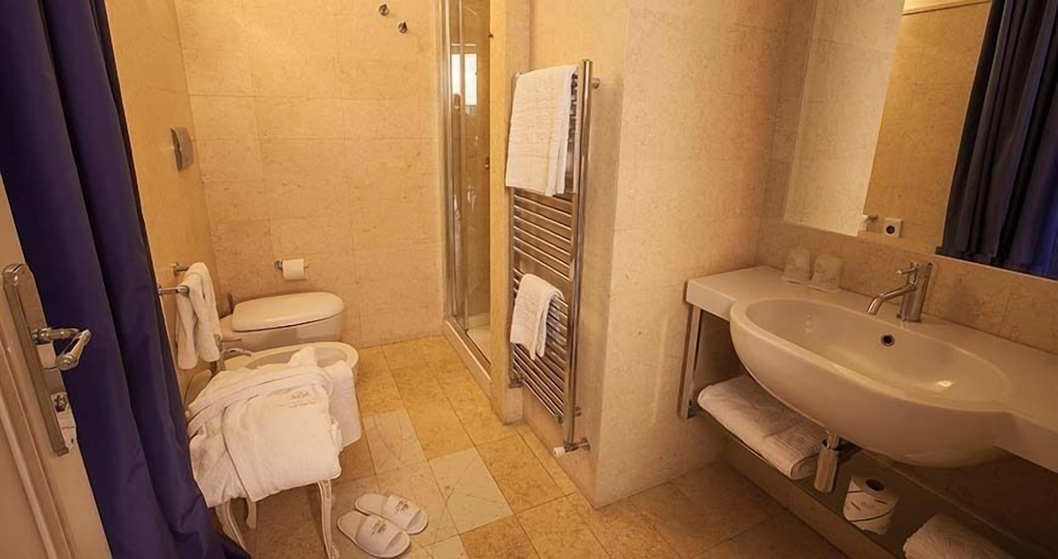 junior suite (limited offer) | bathroom | shower, rainfall showerhead, hair dryer, bidet