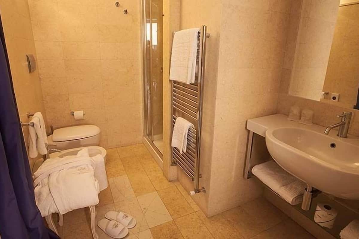 junior suite (limited offer) | bathroom | shower, rainfall showerhead, hair dryer, bidet