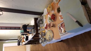 A dining table set with various dishes and utensils, a knife, and a kettle. - Hotel Plagwitzer Hof (Leipzig)