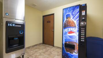 A vending machine area with an ice dispenser and a Pepsi vending machine.