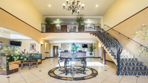 A spacious lobby with a central round table, a staircase, and a reception desk. - Comfort Inn & Suites Cedar City South (Cedar City)