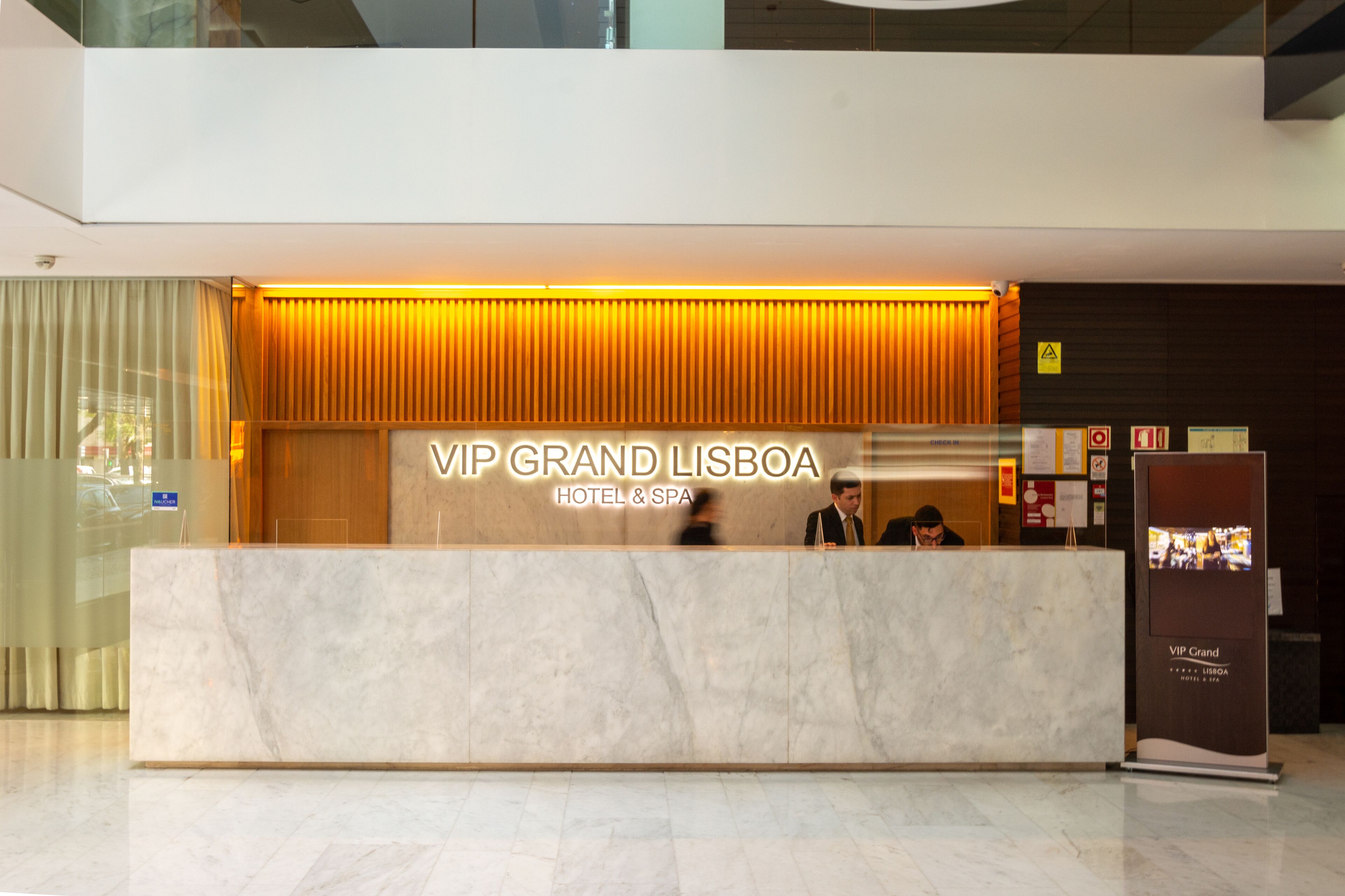 Ein Empfangsschalter mit einem Schild, auf dem ‚VIP Grand Lisboa Hotel & Spa‘ steht.