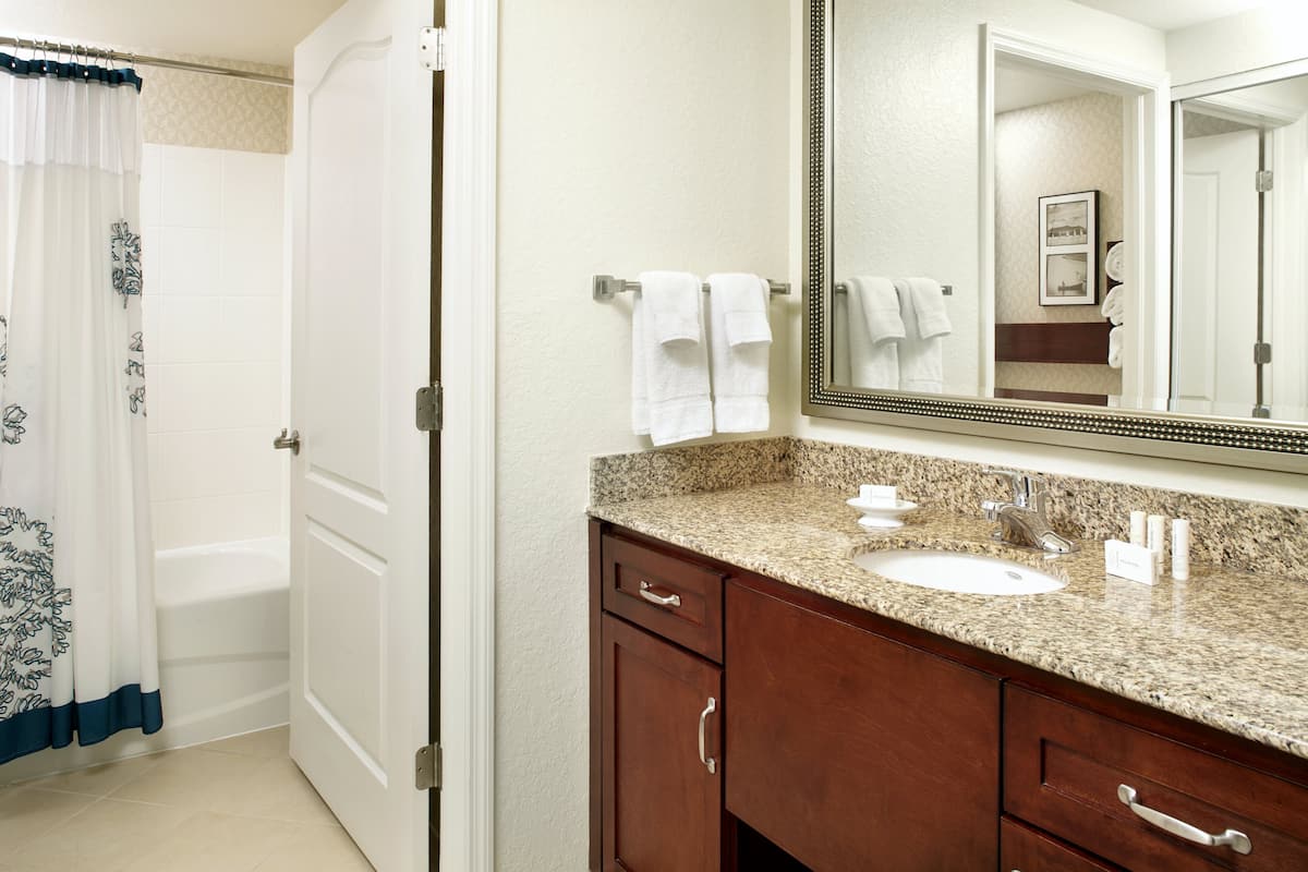 suite, 2 bedrooms, smoking (mobility/hearing accessible, tub) | bathroom | combined shower/bathtub, designer toiletries, hair dryer, towels