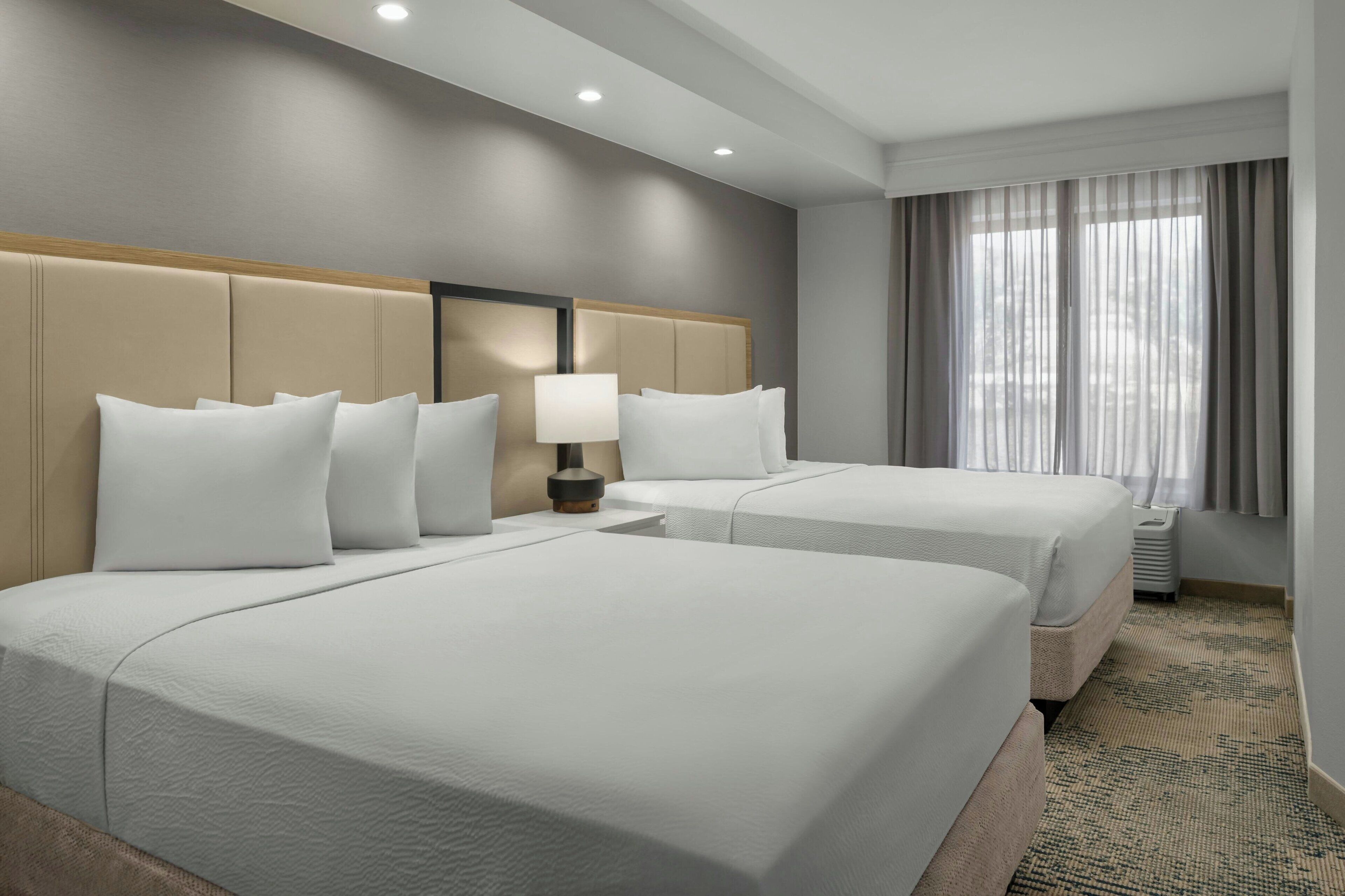 Premium bedding, desk, laptop workspace, blackout drapes