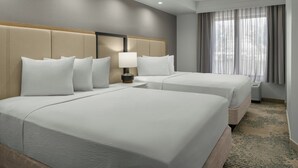 A hotel room with two beds, a nightstand with a lamp, a window with curtains, and a carpeted floor. - SpringHill Suites Lehi at Thanksgiving Point (Lehi)