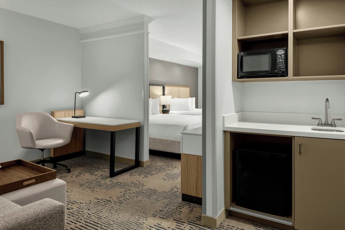 Premium bedding, desk, laptop workspace, blackout drapes