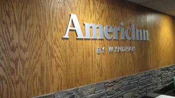 A wooden wall with the text "AmericInn by Wyndham" indicating the hotel name and brand.