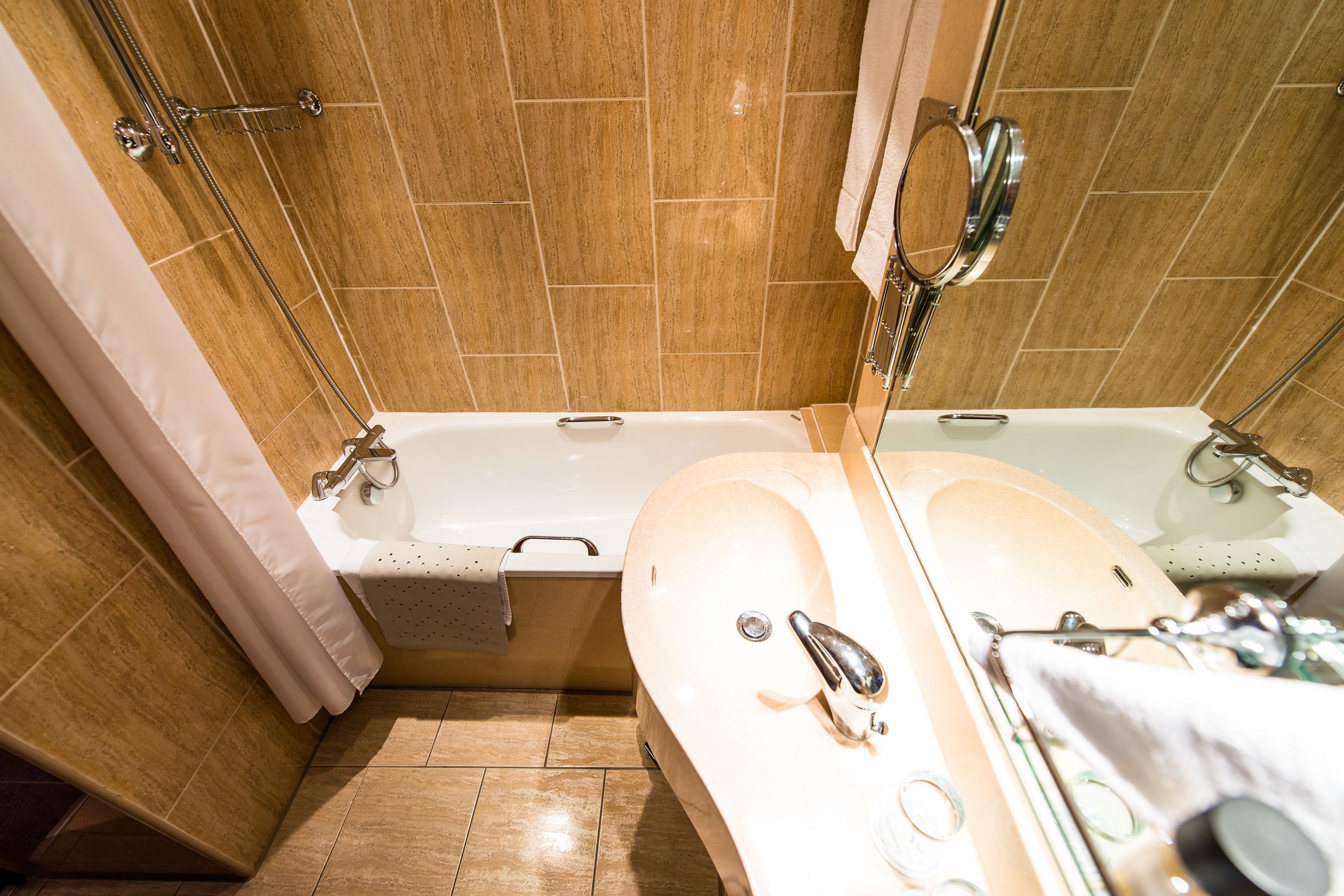 combined shower/bathtub, designer toiletries, hair dryer, towels