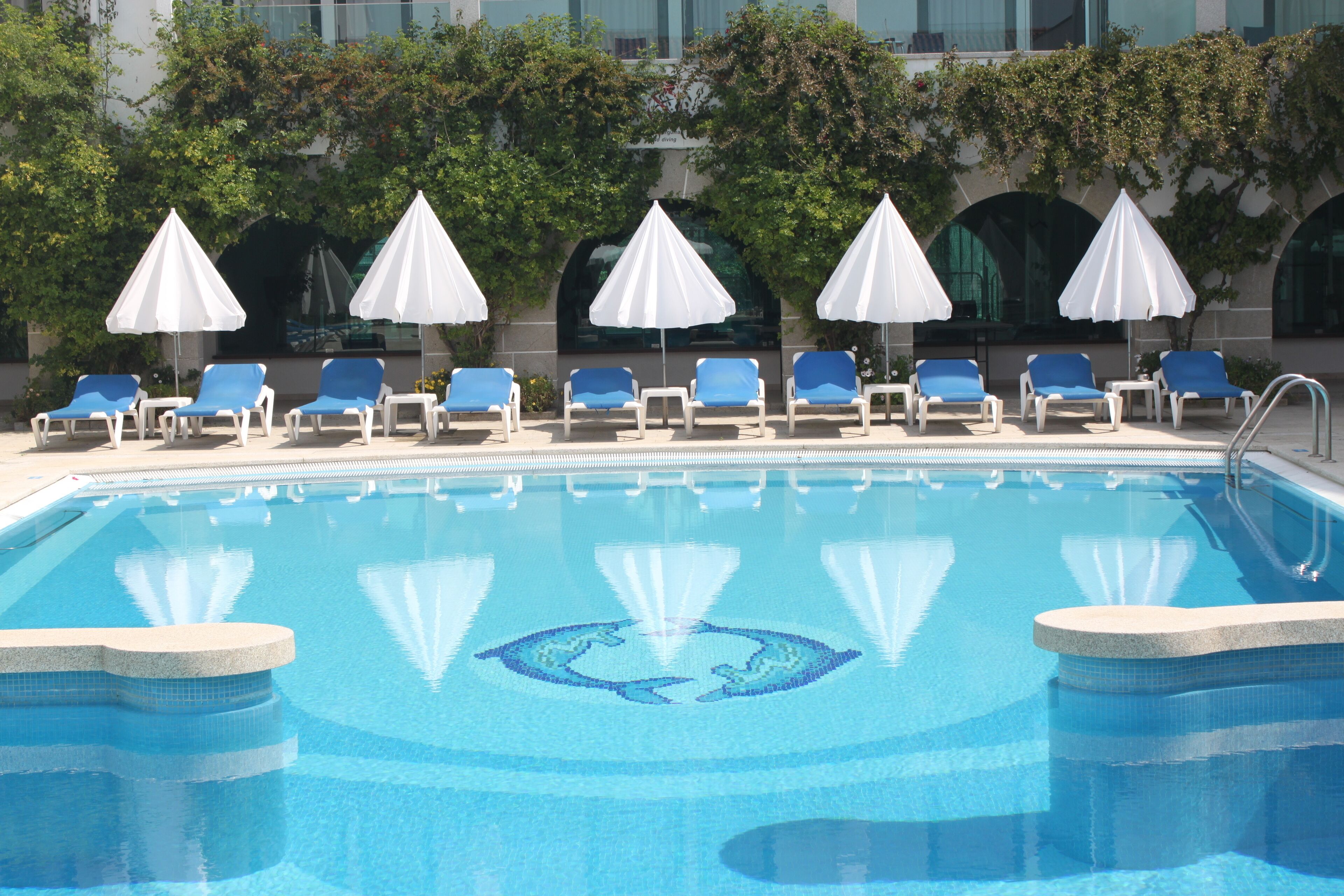 seasonal outdoor pool, open 10:00 am to 7:00 pm, pool umbrellas
