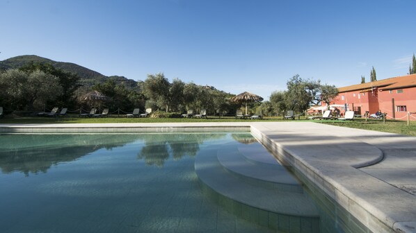 Seasonal outdoor pool, a waterfall pool, pool umbrellas, pool loungers