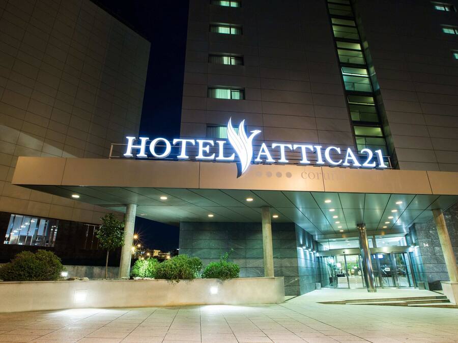 The exterior of Hotel Attica21 with a prominent entrance, a modern architectural design, and a well-lit facade.