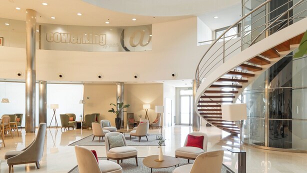 A multi-level atrium with a central staircase, modern furniture, and a spacious lobby area. - Hotel Attica21 Coruña (A Coruña)