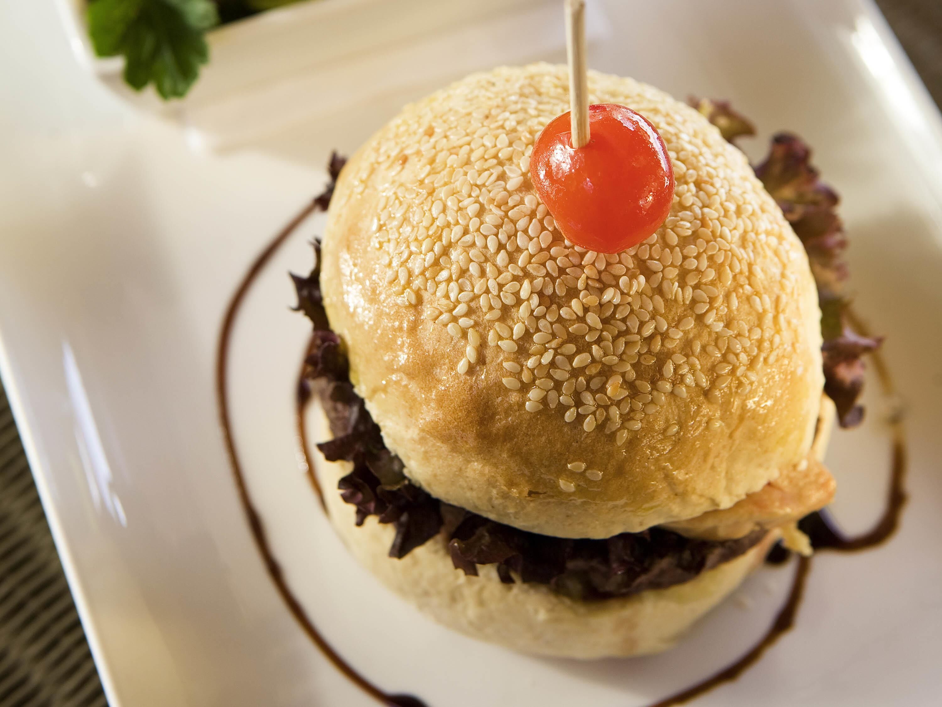 A sandwich with sesame seeds on a white plate.