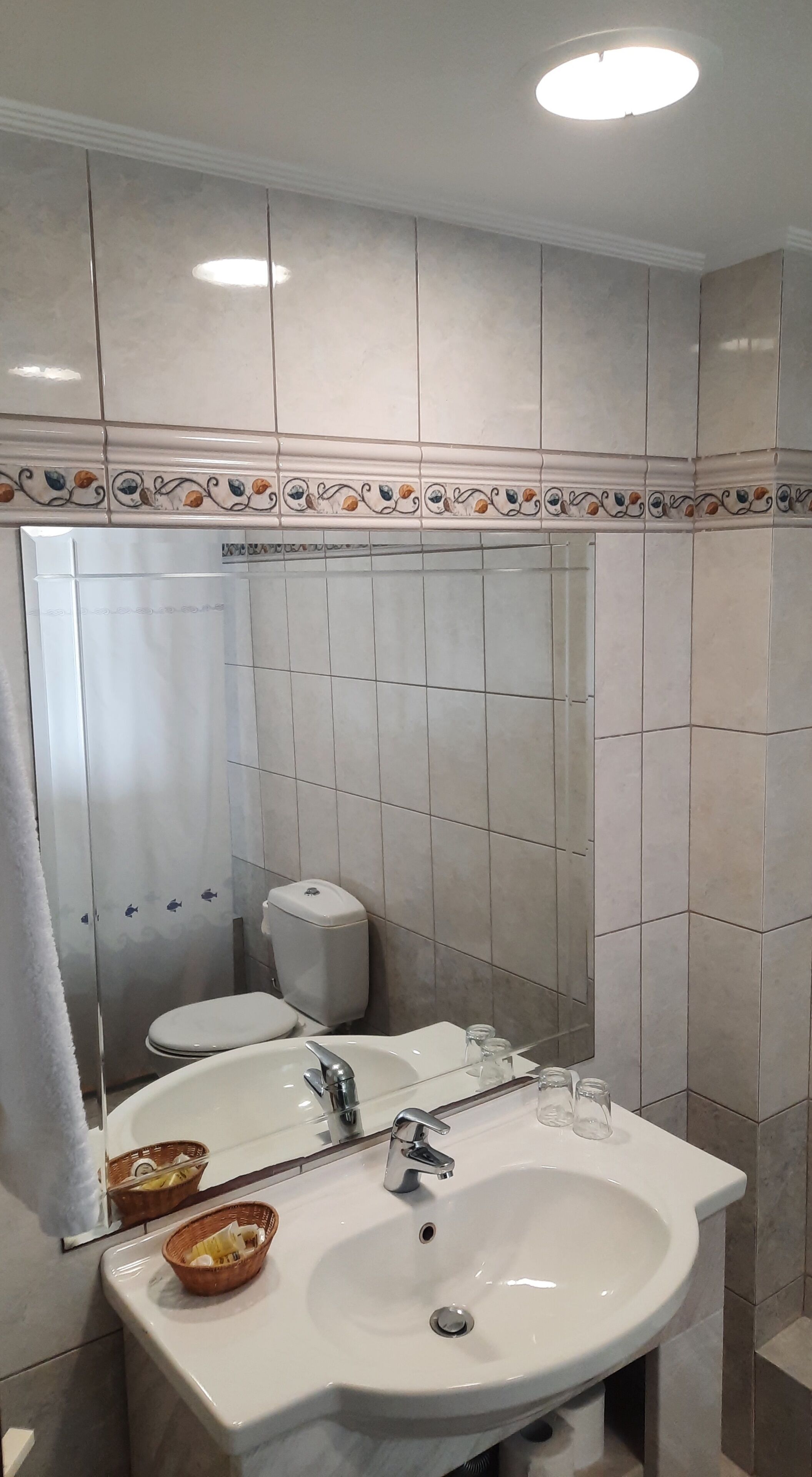 A bathroom with two sinks, a toilet, and a shower.