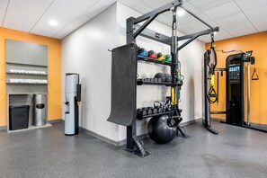A gym with a pull-up bar, kettlebells, and a squat rack. - Hilton Garden Inn Mystic/Groton (Groton)