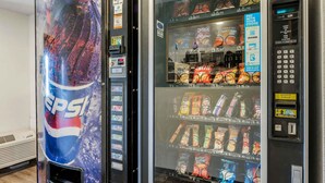 A vending machine with Pepsi and a snack vending machine with various snacks.