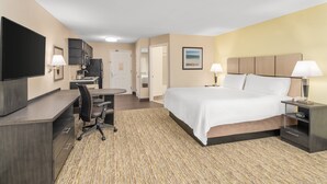 A hotel room with a bed, desk, chair, TV, and a small kitchenette. - Candlewood Suites Destin-Sandestin by IHG (Miramar Beach)
