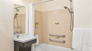A modern bathroom with a bathtub, a shower, a sink, and a mirror. - Candlewood Suites Destin-Sandestin by IHG (Miramar Beach)