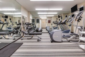 A gym with various exercise equipment, including treadmills, ellipticals, and weight machines. - Candlewood Suites Destin-Sandestin by IHG (Miramar Beach)