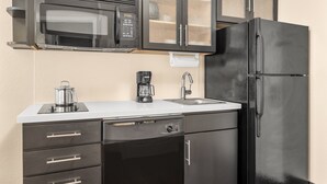A kitchen with a microwave, coffee maker, sink, and a refrigerator. - Candlewood Suites Destin-Sandestin by IHG (Miramar Beach)