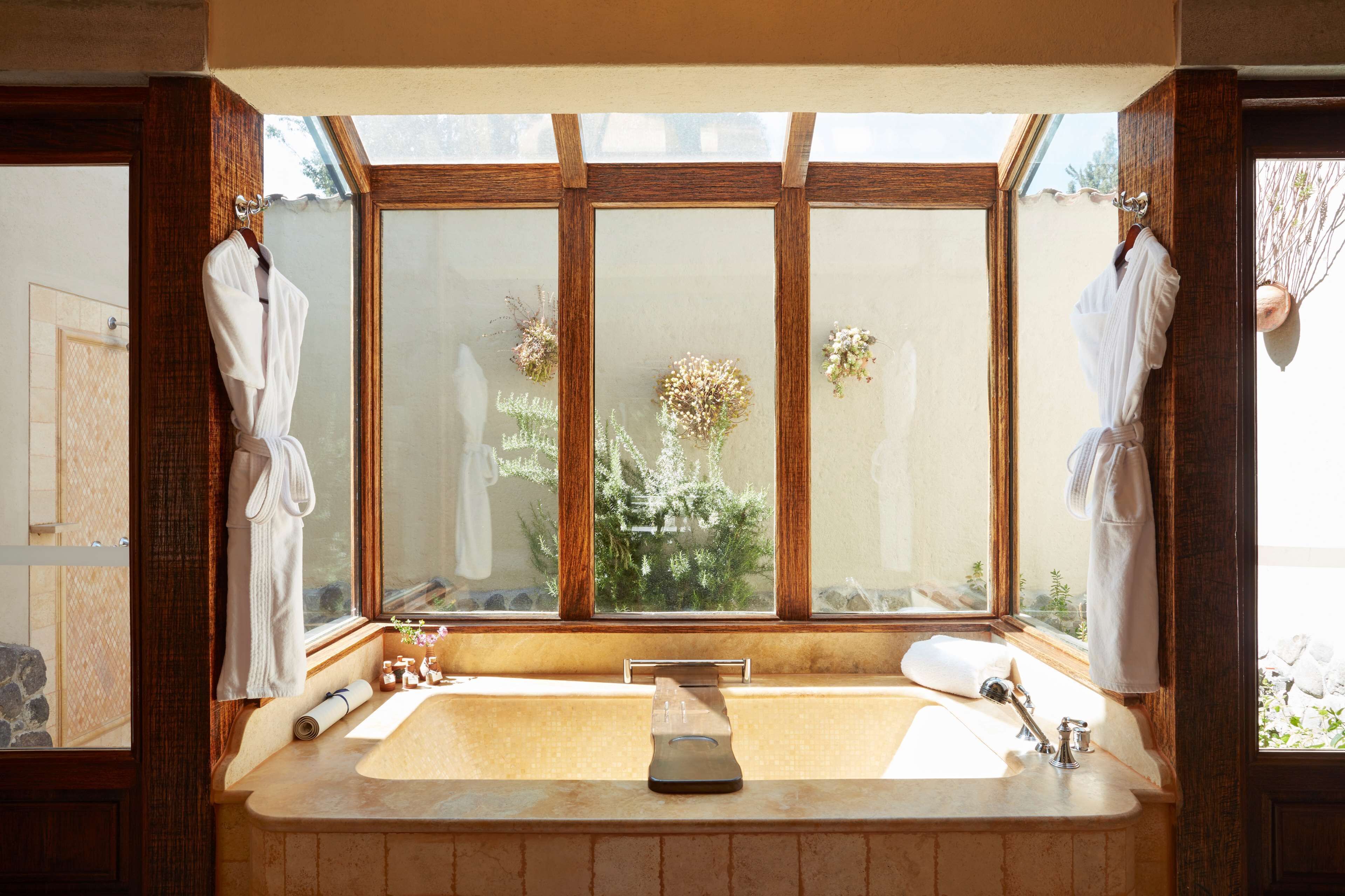 separate bathtub and shower, deep-soaking bathtub, rainfall showerhead