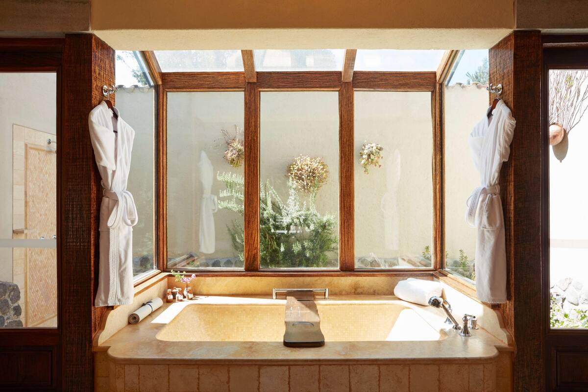 separate bathtub and shower, deep-soaking bathtub, rainfall showerhead