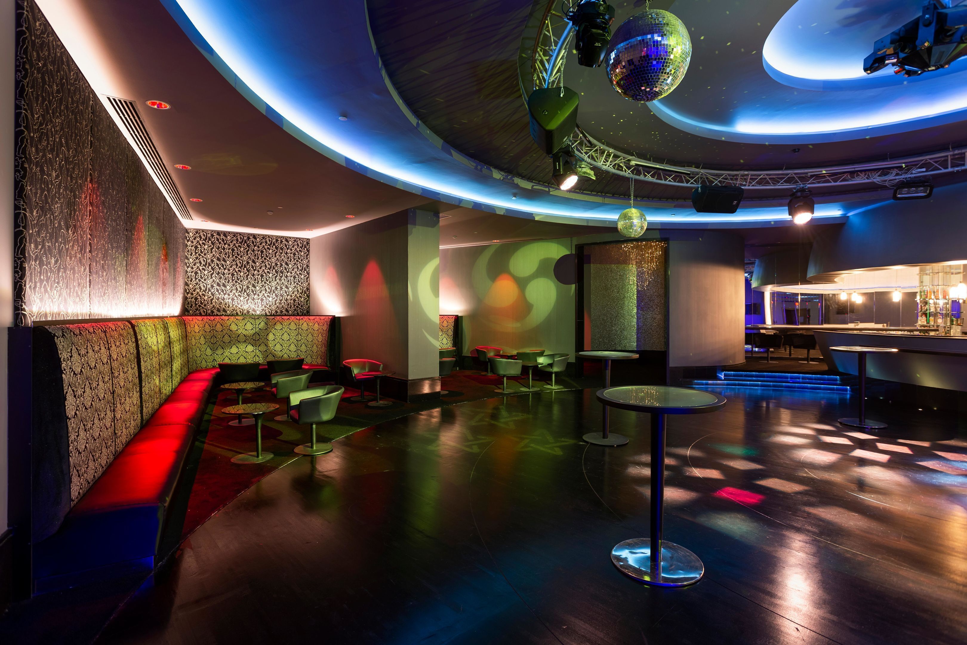 Un espace de détente moderne doté d’un plafond incurvé, de sièges et d’un bar.
