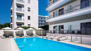 A modern hotel with a swimming pool, sun loungers, and umbrellas. -  Angela Downtown Hotel  (Rhodes)