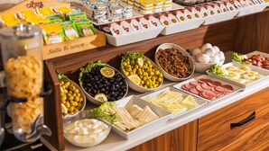 A buffet with various food items including cheeses, olives, meats, and eggs. - Ala Sofia Hotel (Istanbul)