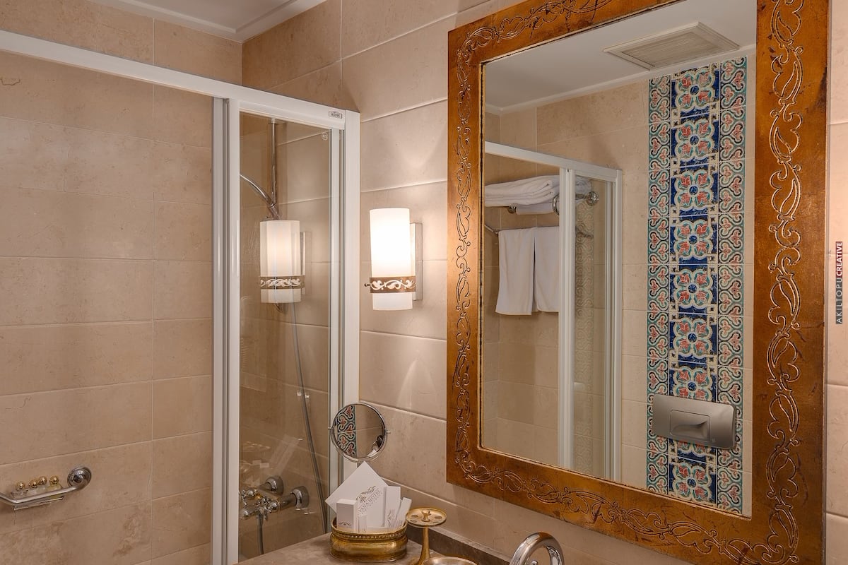 designer toiletries, hair dryer, slippers, towels