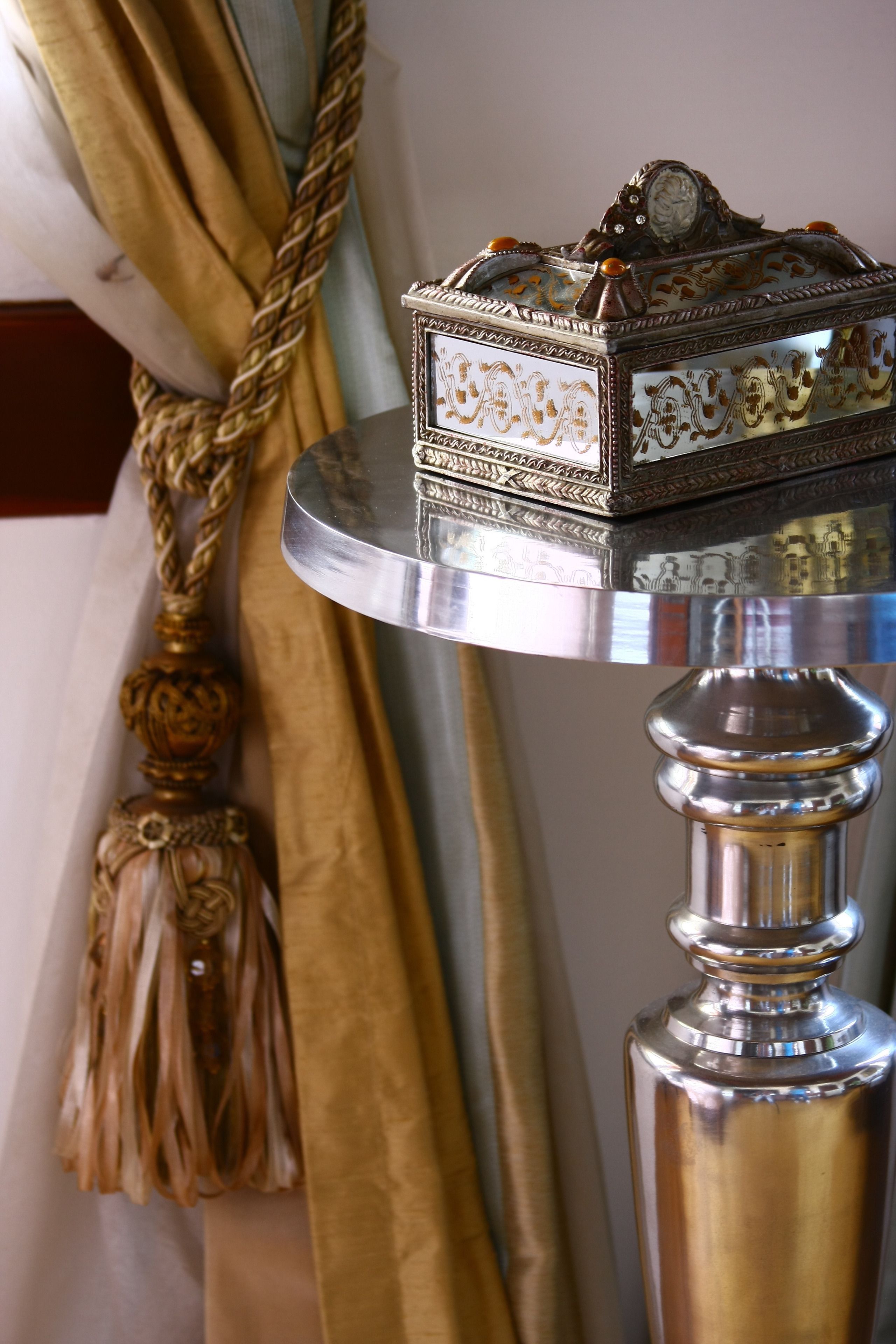 A decorative box on a metallic table with intricate designs.