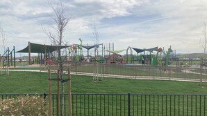 A playground with various play structures and a fenced area. - Holiday Inn Express & Suites Lathrop by IHG (Lathrop)