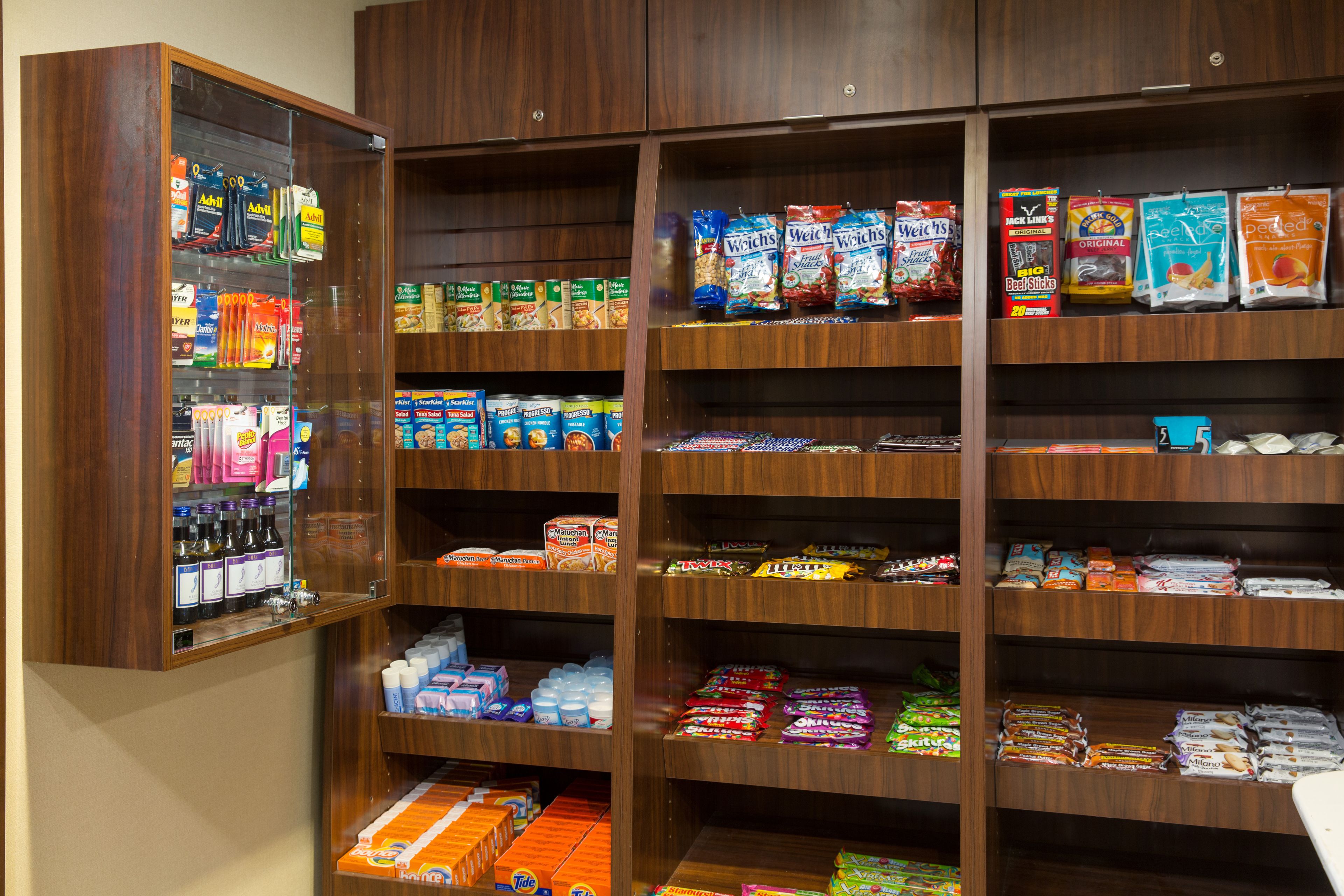 A well-stocked snack and beverage section with various brands and types of products.
