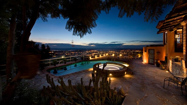 A pool area with a hot tub, surrounded by cacti and a stone patio. - Casa Cordelli (San Miguel de Allende)