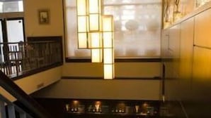 A staircase with a modern design, featuring a black railing and a unique hanging light fixture. - Ribera Sur Hotel (Buenos Aires)