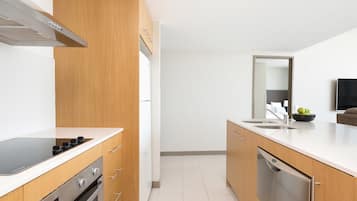 A modern kitchen with wooden cabinets, a stainless steel dishwasher, and a black stove.