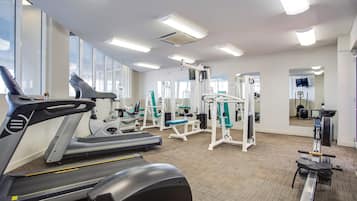A gym with treadmills, weight machines, and exercise equipment.