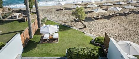 A pool area with a view of the beach and ocean.