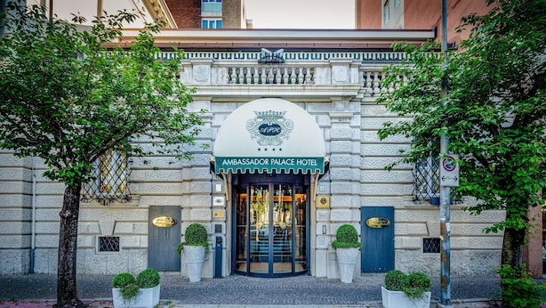 The Ambassador Palace Hotel entrance with a classic facade, a central entrance, and symmetrical landscaping. - Ambassador Palace Hotel (Udine)