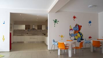Enjoy meals in a vibrant dining area with a colorful mural and comfortable seating.