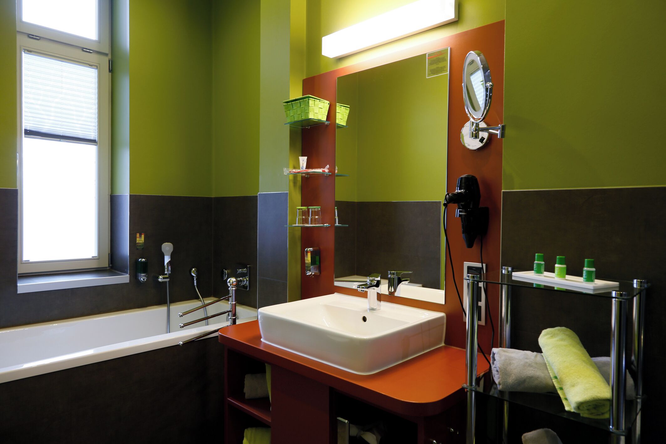 A bathroom with a white sink, a mirror, and a towel rack.