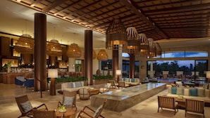 A spacious lobby with a bar area, seating arrangements, and large windows offering views of the outdoors. - Secrets Maroma Beach Riviera Cancun - Adults Only - All inclusive (Playa del Carmen)