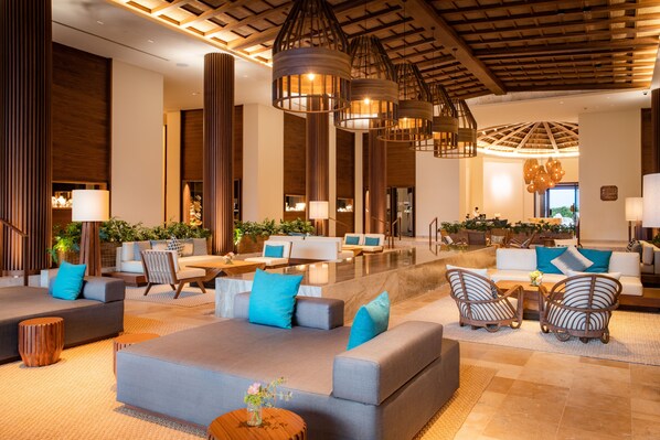 A spacious lobby with modern furniture, including sofas and chairs, and a central seating area with a coffee table. - Secrets Maroma Beach Riviera Cancun - Adults Only - All inclusive (Playa del Carmen)
