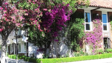 Stunning garden views from the balcony, surrounded by vibrant flowers and lush greenery.