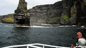 A rocky coastline with a prominent cliff formation.