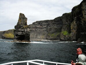 A rocky coastline with a prominent cliff formation.
